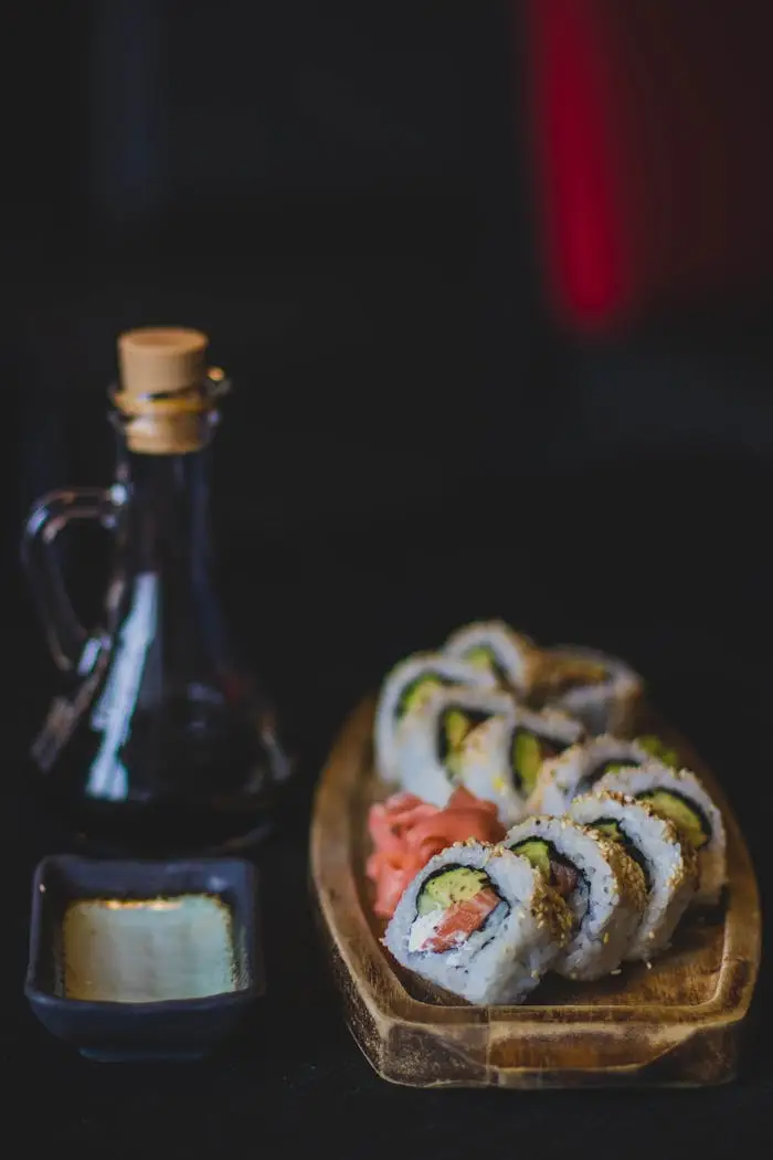 pexels-photo-1028427 Artistic sushi rolls with soy sauce and wasabi in a restaurant setting.