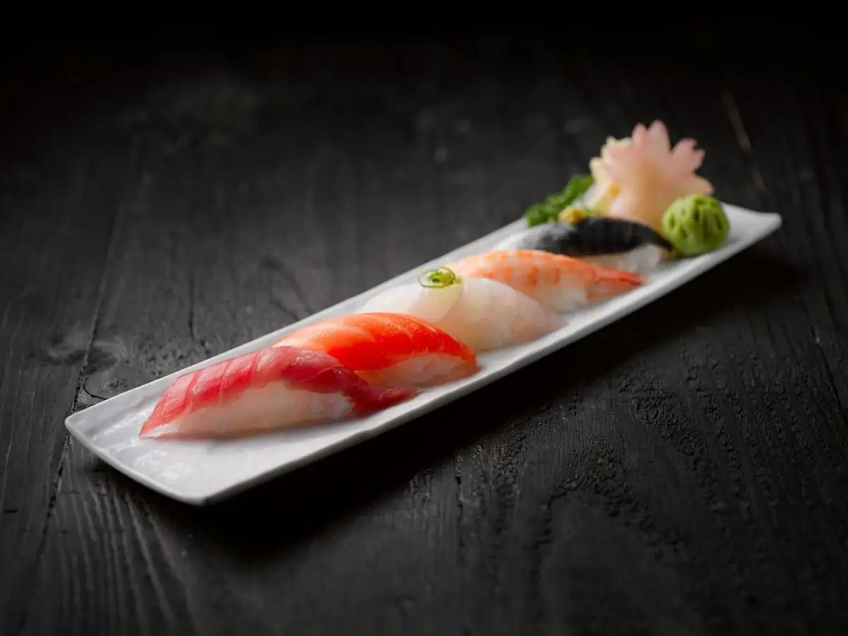 pexels-photo-2098143-2098143 Elegant sushi platter featuring assorted seafood sushi on dark wood table.
