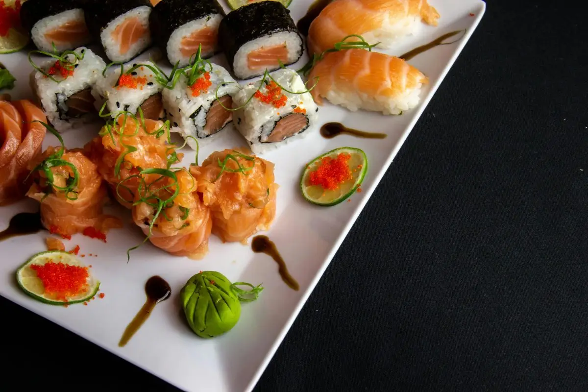 pexels-photo-3763816-3763816 A mouth-watering assortment of sushi including salmon sashimi, maki rolls, and nigiri on a white plate.